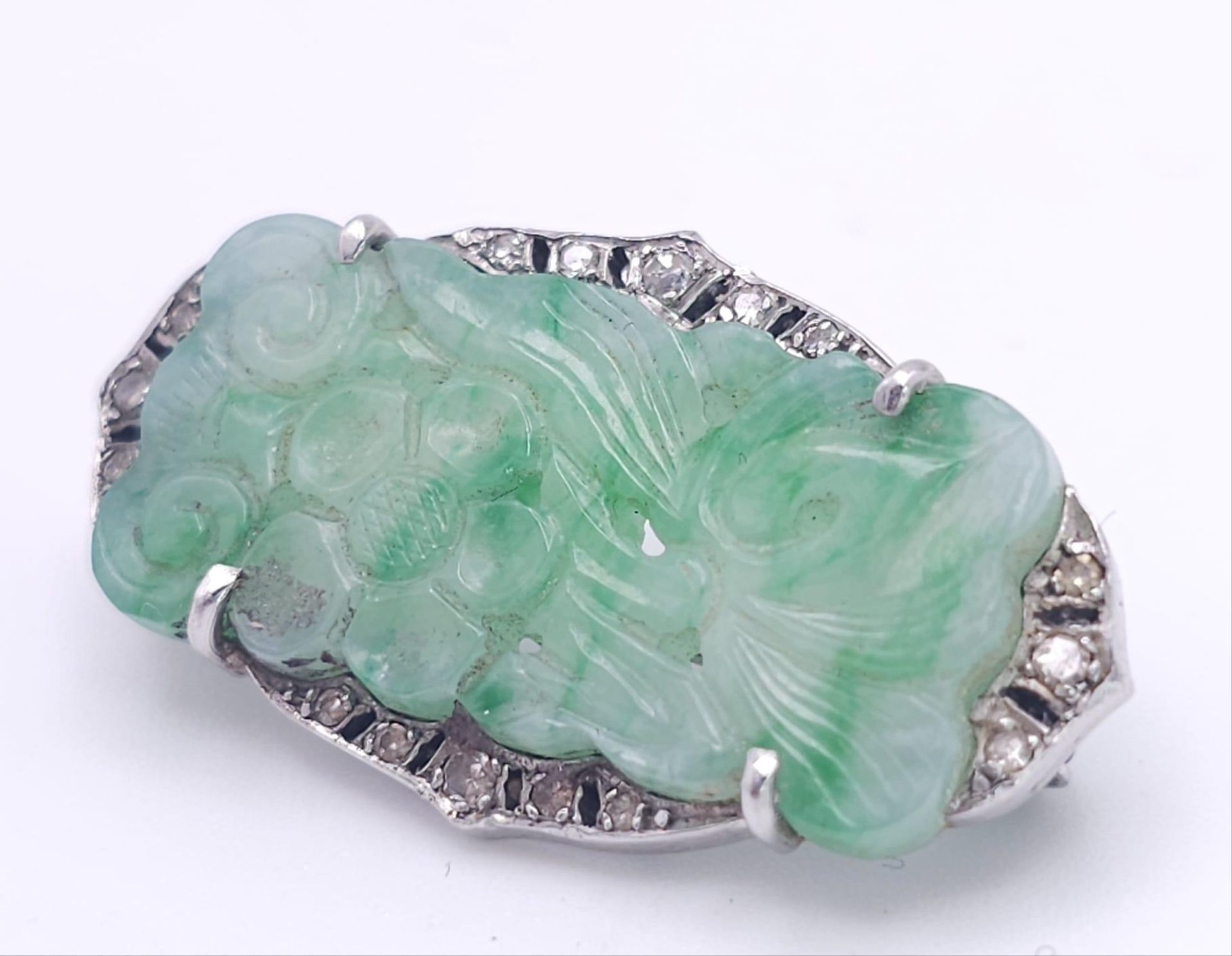 AN ART DECO JADE AND DIAMOND BROOCH SET IN PLATINUM . 6.7gms 3.5cms 15098