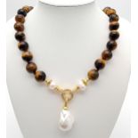 A Rich Tigers Eye Beaded Necklace with a Hanging Keisha Baroque Pearl Pendant. 12mm beads.