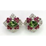 A Pair of Platinum, Emerald, Ruby and Diamond Earrings. Each earring containing a 1.5ct oval cut