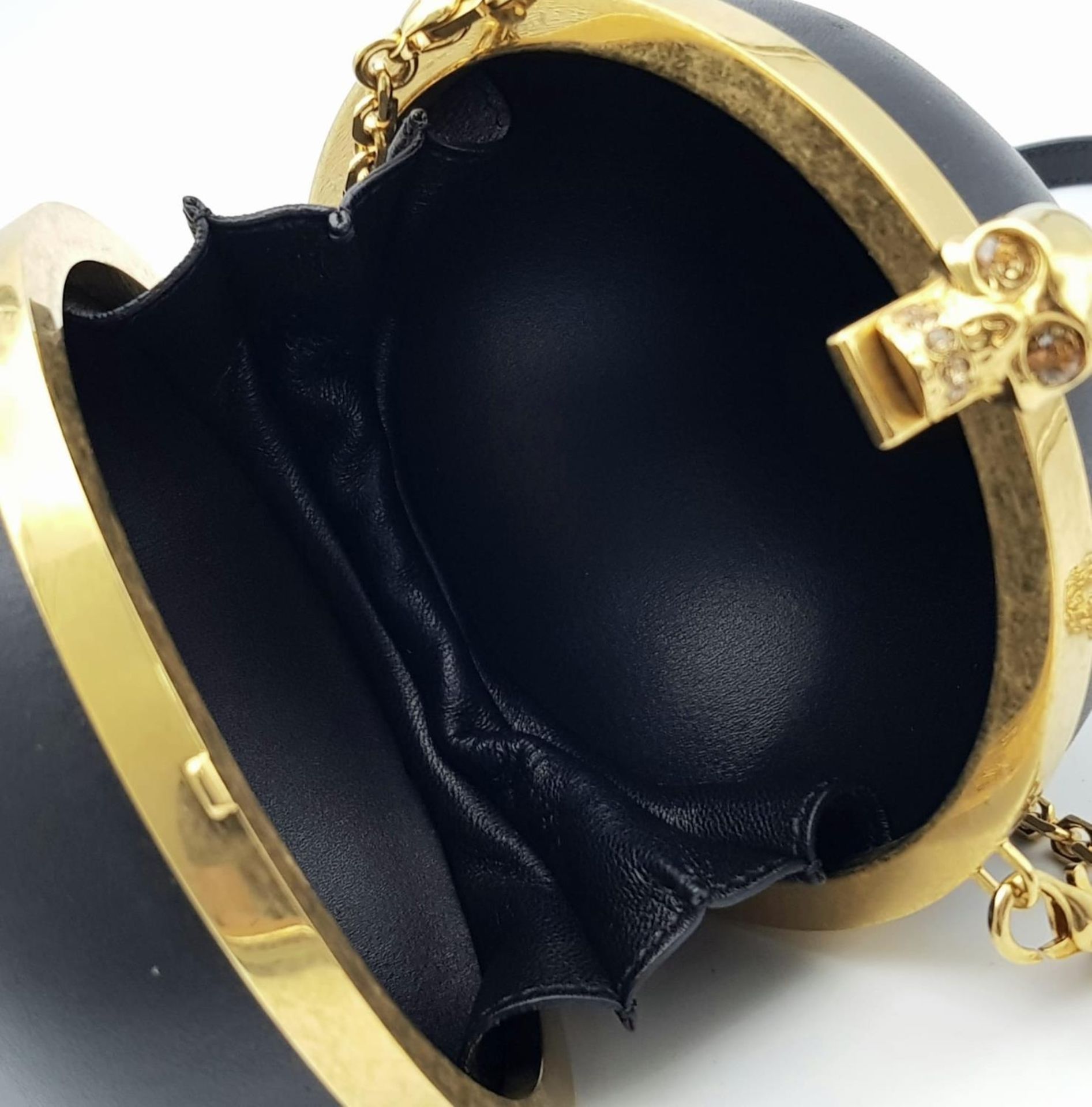 An Alexander Mcqueen Skull Ball Clutch Bag. Black leather exterior with gold tone hardware. - Image 4 of 6