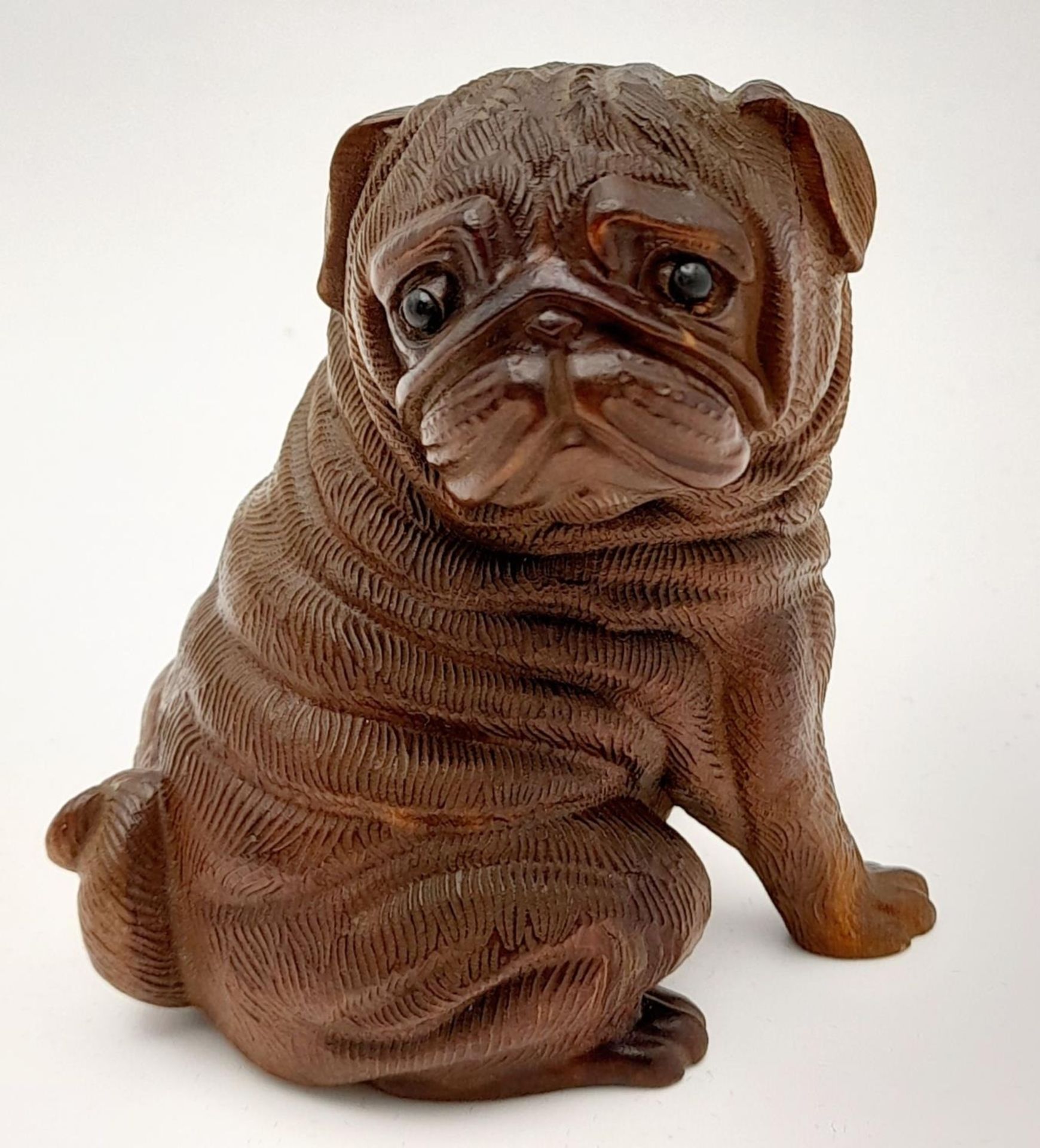 A very collectable, exquisitely hand carved on box wood Pug dog with amazing detail. Probably of