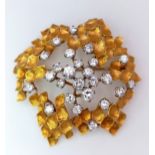A Magical 18K Yellow Gold and Diamond Brooch. 1.5ctw of brilliant round cut diamonds amongst