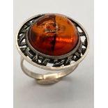 Vintage SILVER and AMBER RING .Having a large AMBER CABACHON set in a Silver Saturn Planet mount.