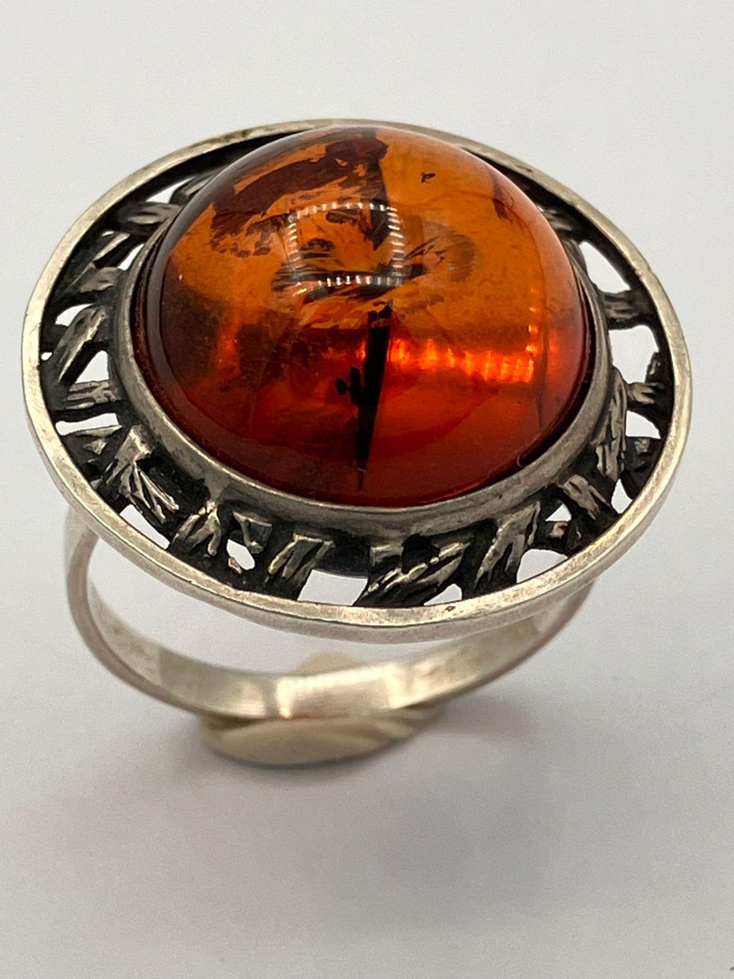 Vintage SILVER and AMBER RING .Having a large AMBER CABACHON set in a Silver Saturn Planet mount.