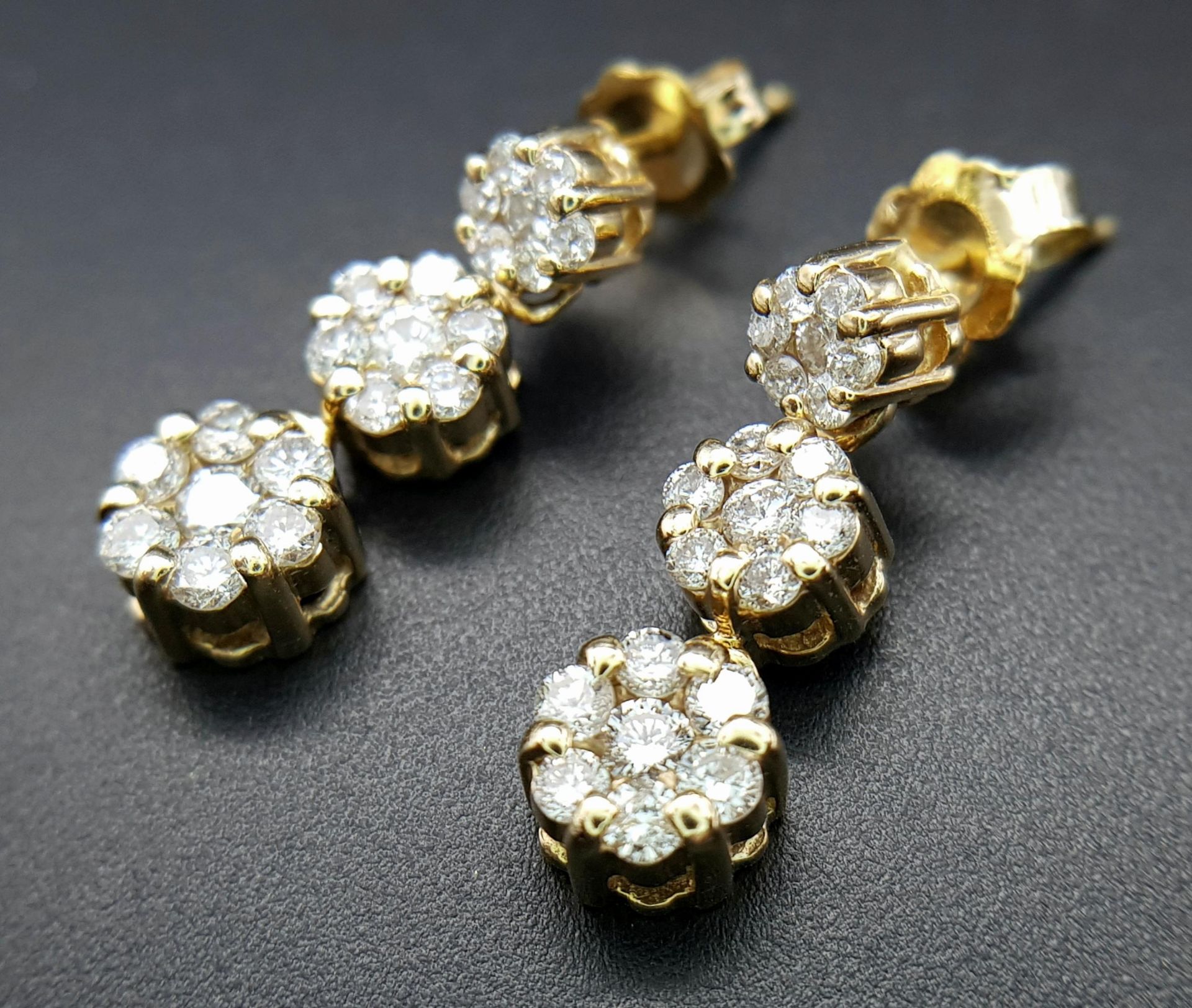 A Pair of 14K Yellow Gold and Diamond Drop Earrings. A total of 42 round cut diamonds - 1ctw. H-I in