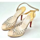 A pair of lightly used high heel (4inch) shoes by Louboutin.
