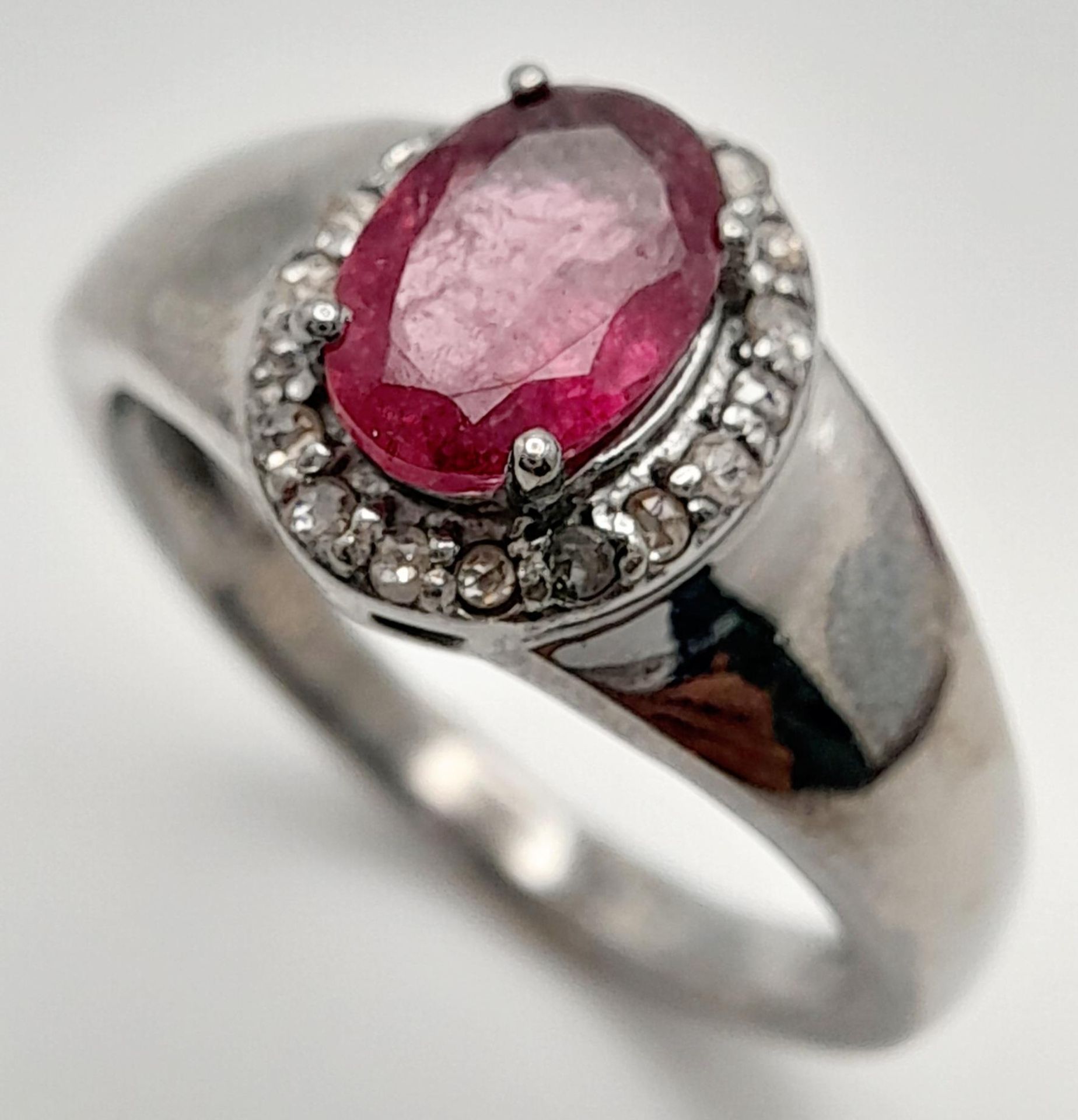 A Rhodolite Garnet and Diamond Ring, Oval cut rhodolite with rose cut diamond surround. Set in 925 - Image 2 of 5