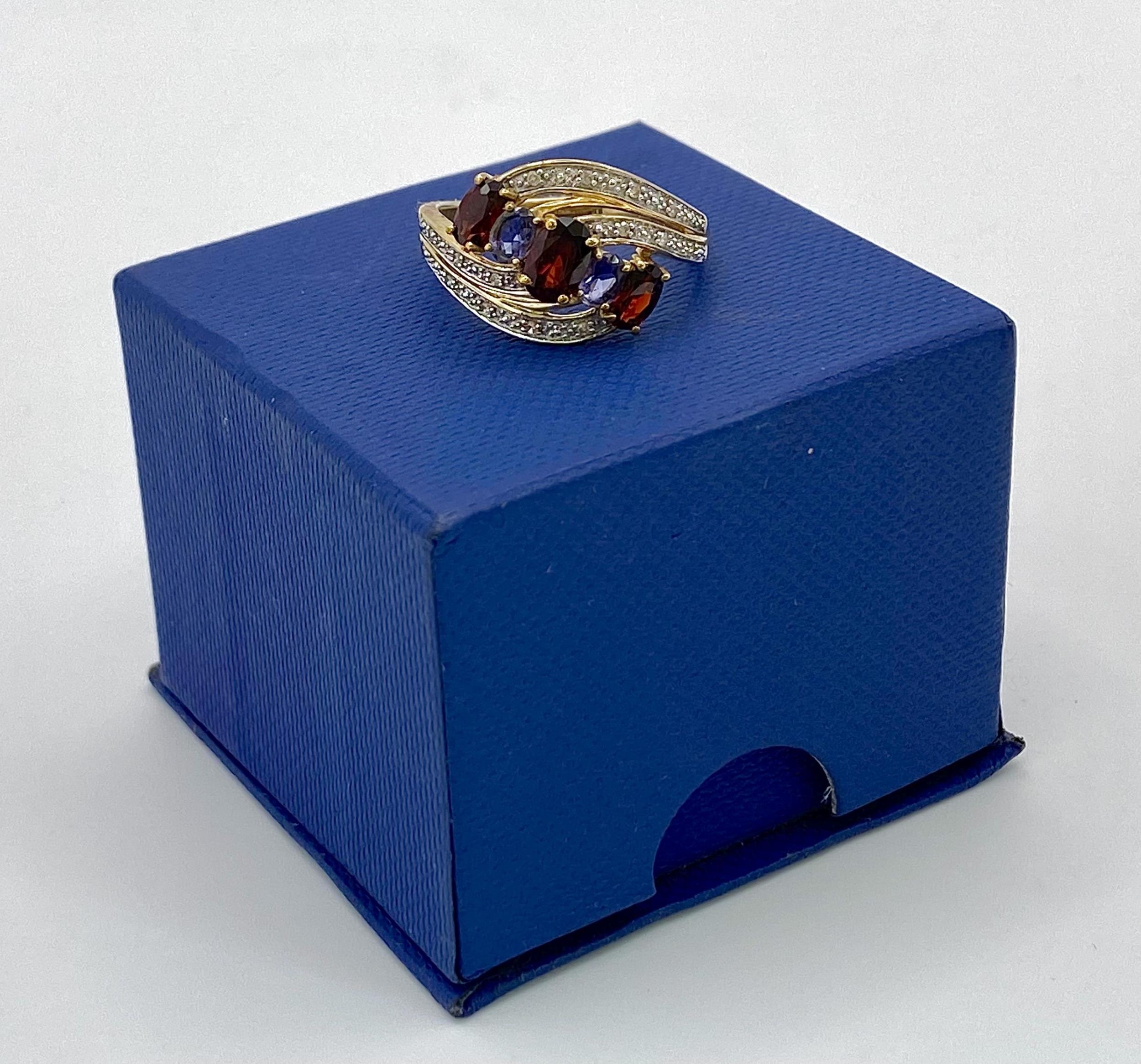 A 9 Carat Yellow Gold Garnet, Tanzanite and Diamond Set Crossover Ring Size P. Crown Measures 1. - Image 7 of 7