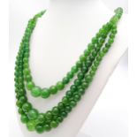 A Green Jade Graduated Three Row Beaded Necklace. 7-14mm beads. Necklace length - 46cm necklace