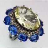 A 14ct Lemon Quartz, Tanzanite and Diamond Ring. Large oval lemon quartz with a 3ctw tanzanite and