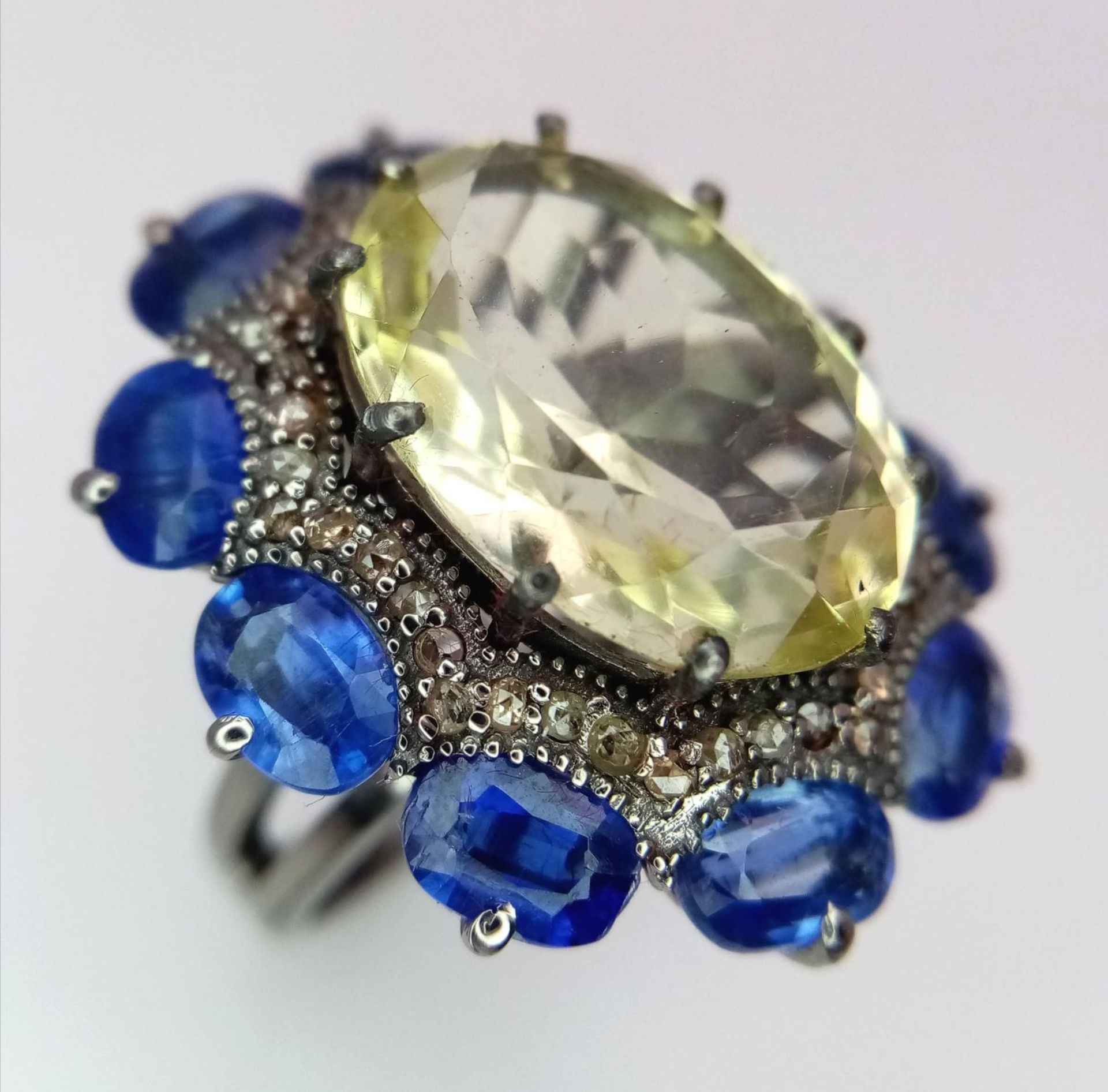 A 14ct Lemon Quartz, Tanzanite and Diamond Ring. Large oval lemon quartz with a 3ctw tanzanite and