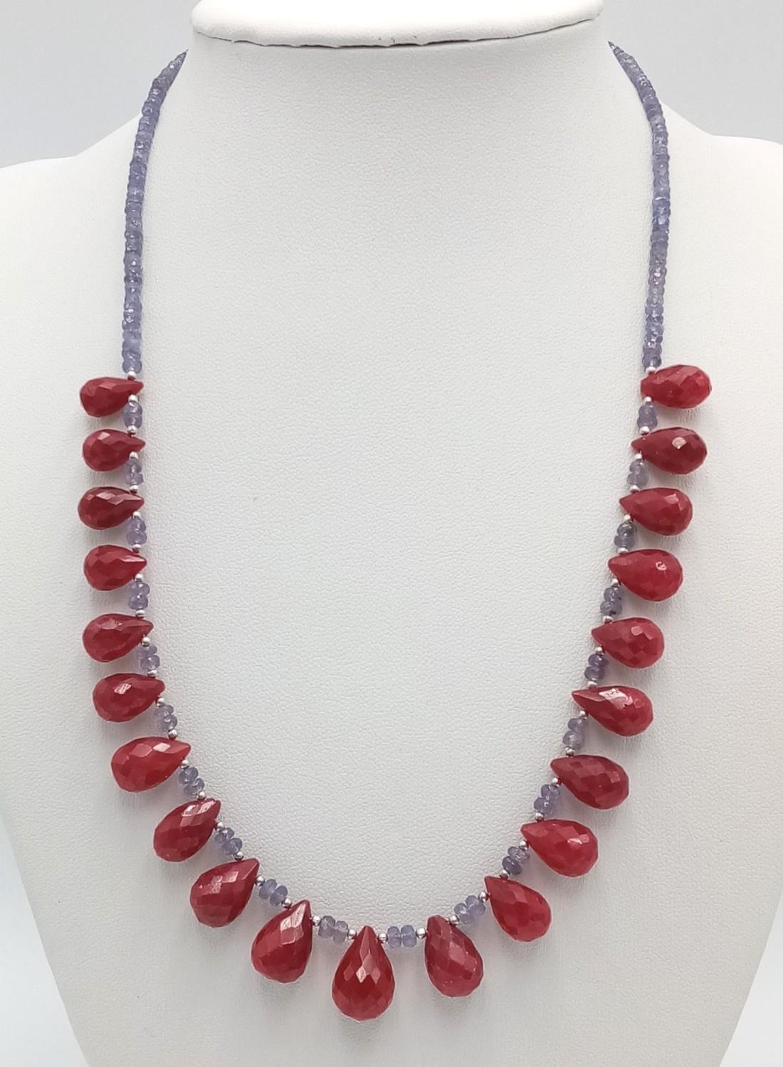 A Tanzanite Small Rondelle Necklace with Ruby Drops. 925 Silver Clasp. 150ctw gemstones. 42cm