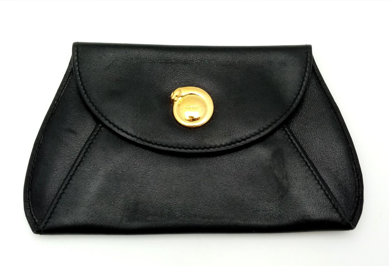A Cartier Black Panther Coin Pouch. Leather exterior with gold-toned hardware and press stud