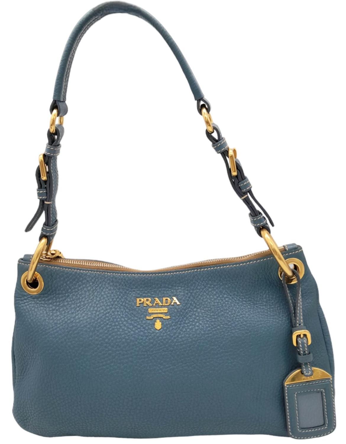A Prada Marine Blue Vitello Daino Shoulder Bag. Leather exterior with gold-toned hardware,