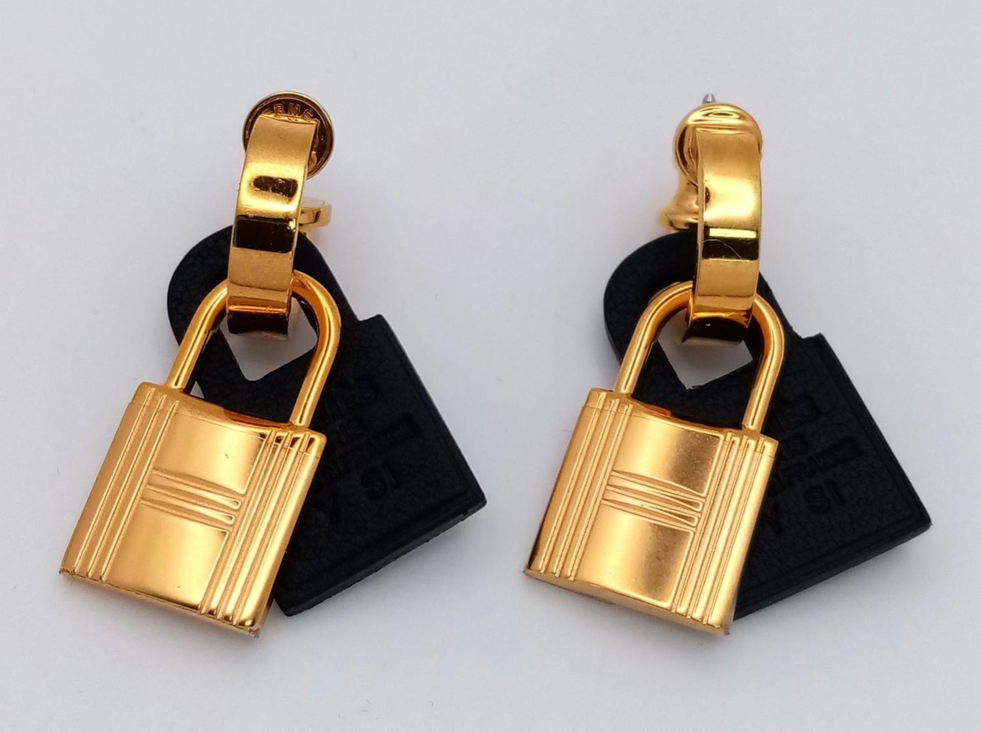 A Pair of Designer Gold Plated Hermes Padlock Earrings. Comes with original packaging.