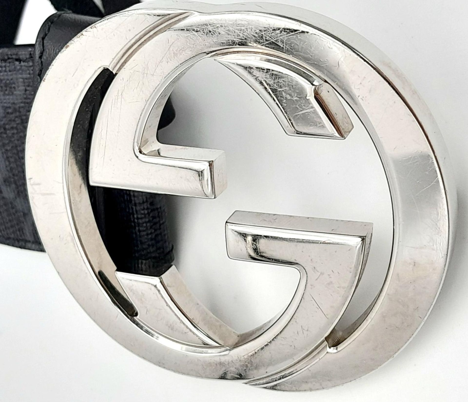 A Gucci Black with Grey Monogram Men's GG Belt. Silver-toned hardware. Approximately 104.5cm length, - Image 7 of 7