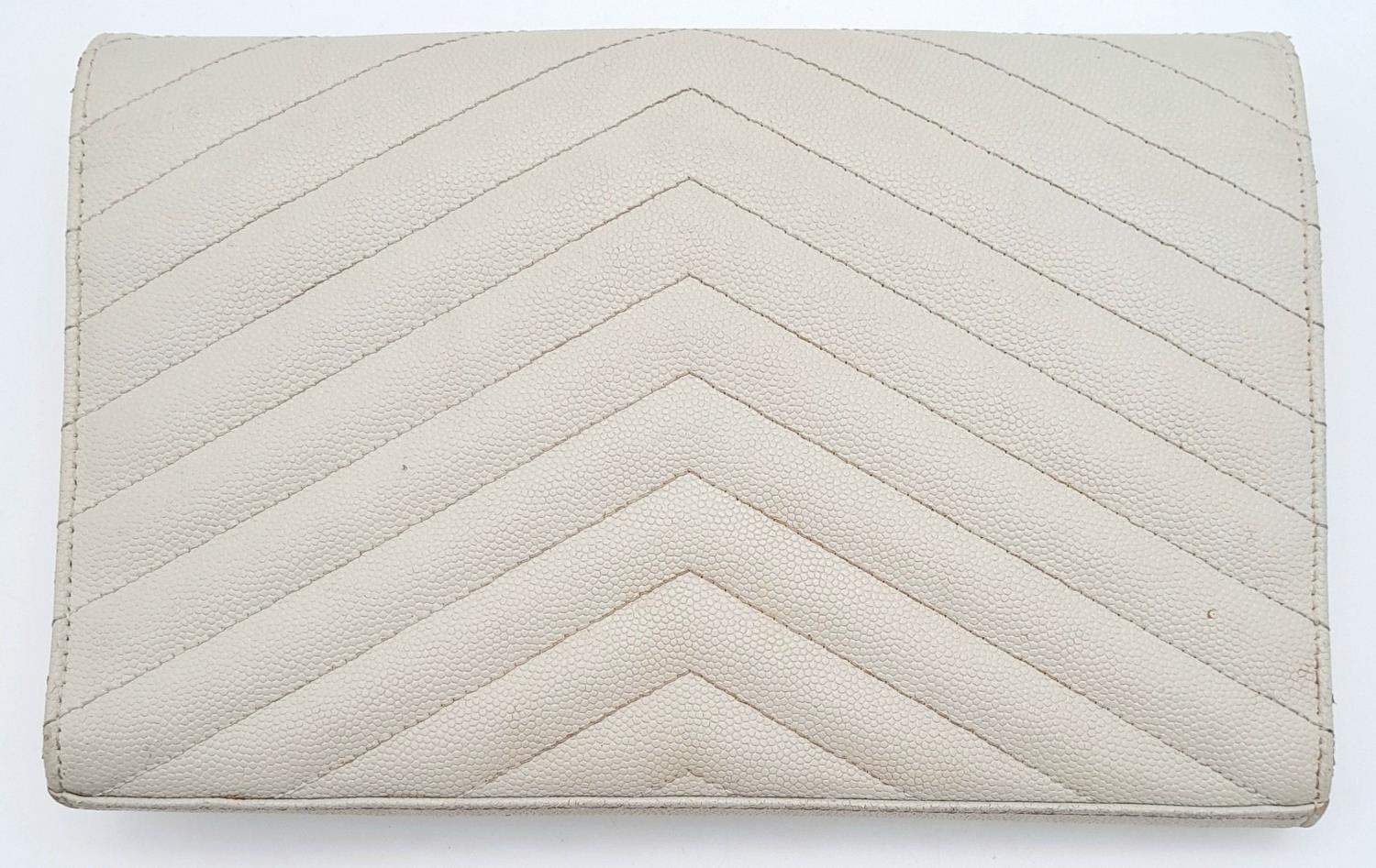 A YSL Ivory Cassandre Wallet Bag. Leather exterior with gold-toned hardware, the iconic YSL logo, - Image 2 of 13