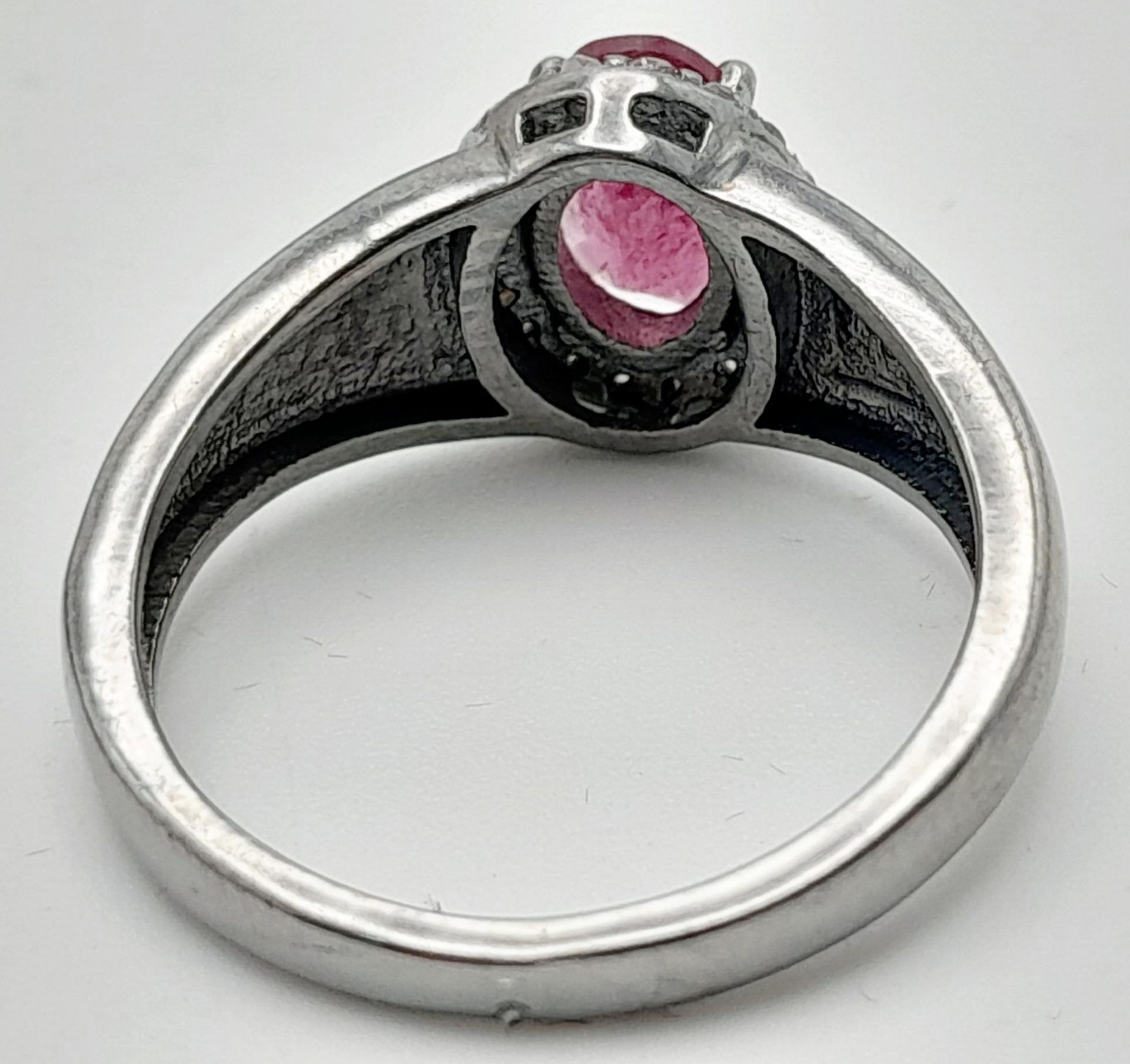 A Rhodolite Garnet and Diamond Ring, Oval cut rhodolite with rose cut diamond surround. Set in 925 - Image 3 of 5