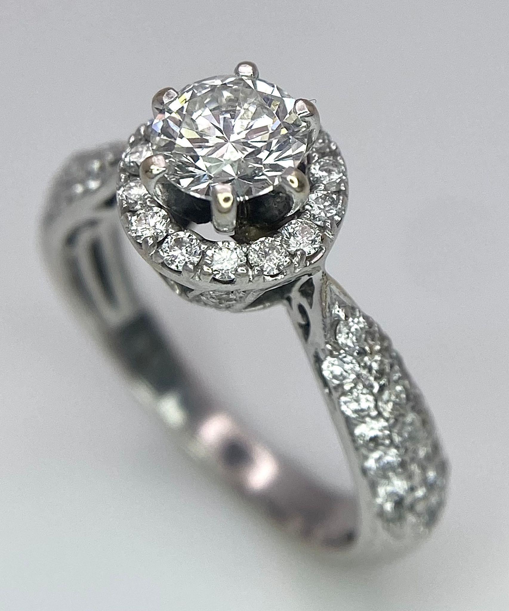 An 18K White Gold Diamond Ring. Central 0.75ct brilliant round cut diamond with a diamond halo and - Image 2 of 10