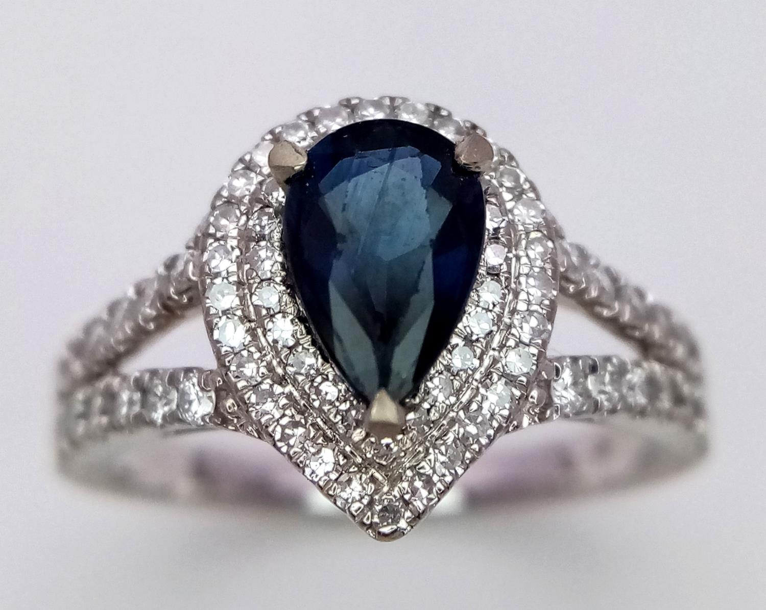 An 18K White Gold Sapphire and Diamond Ring. Teardrop sapphire with a 0.50ctw diamond surround. Size - Image 2 of 5