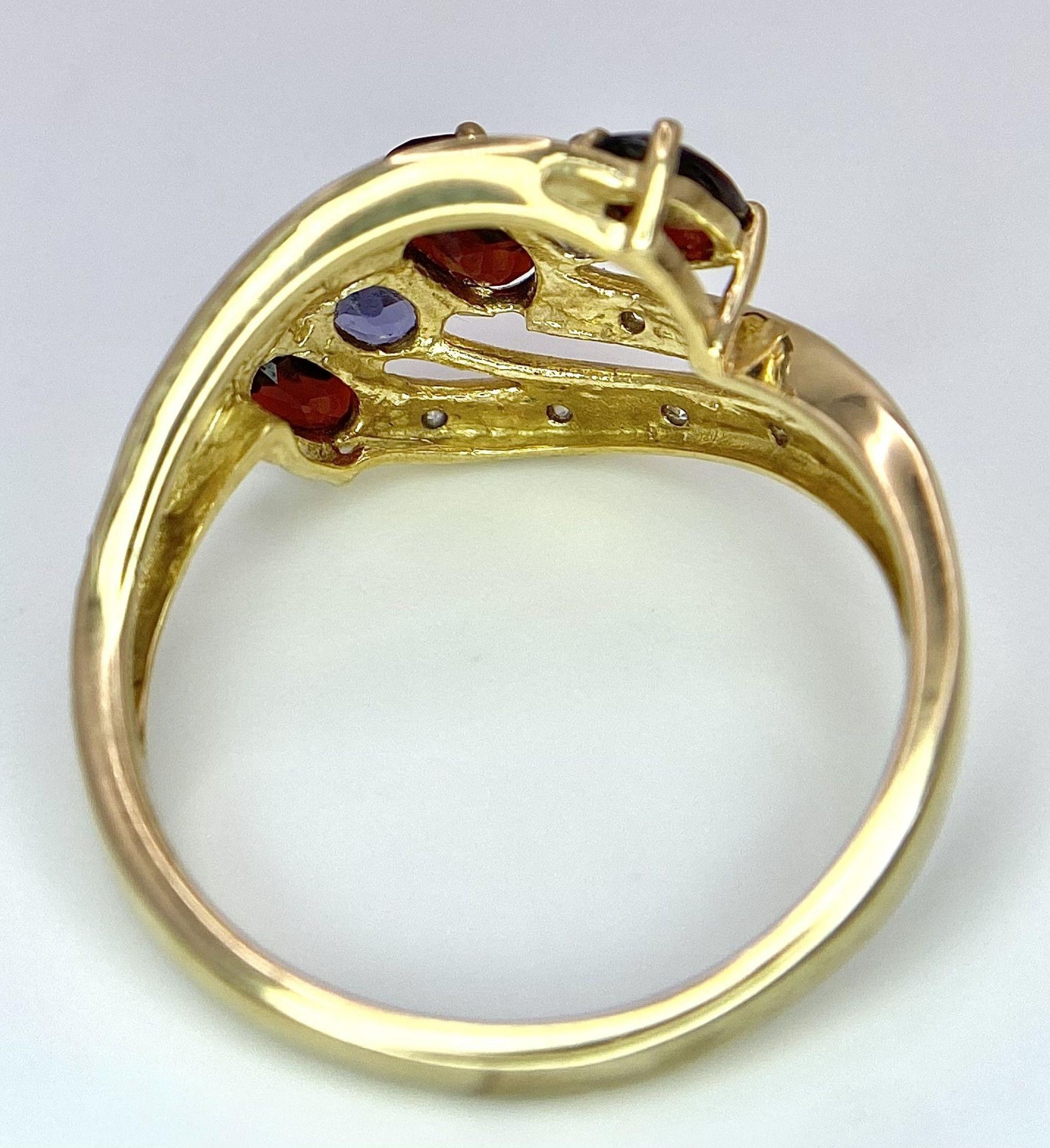 A 9 Carat Yellow Gold Garnet, Tanzanite and Diamond Set Crossover Ring Size P. Crown Measures 1. - Image 5 of 7