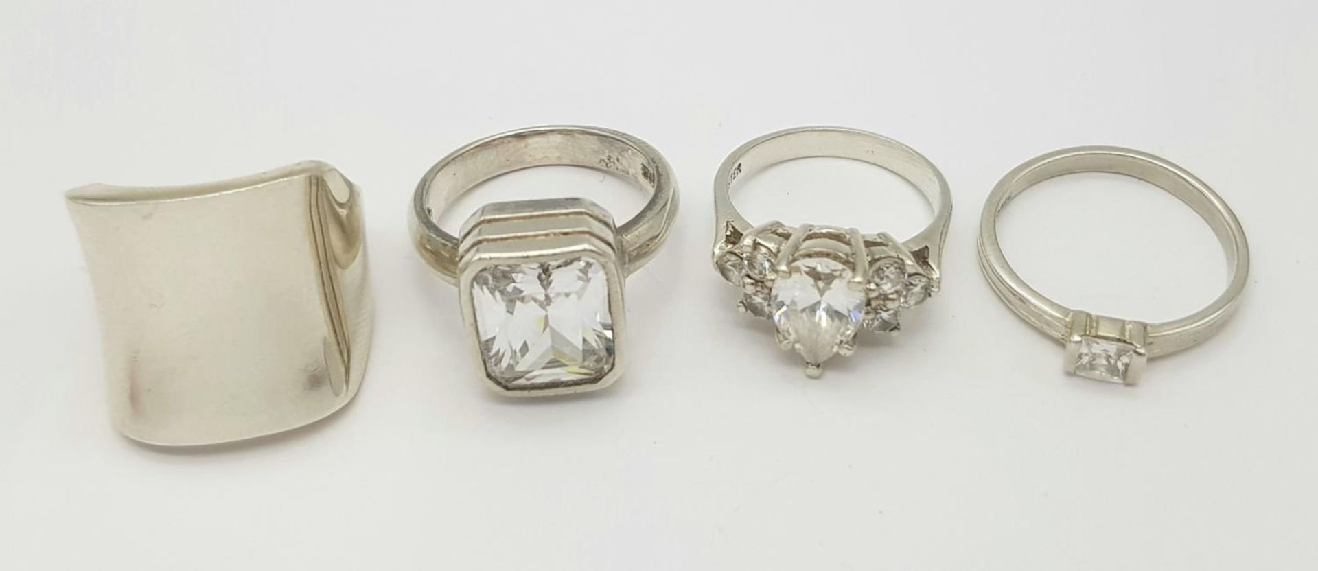 A Selection of 4 sterling silver rings, some set with cubic zirconia, sizes N-R, total weight 28.3g.