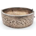 A Silver Victorian Engraved Bangle. 6.3cm diameter, 3cm band width, 43.69g weight.