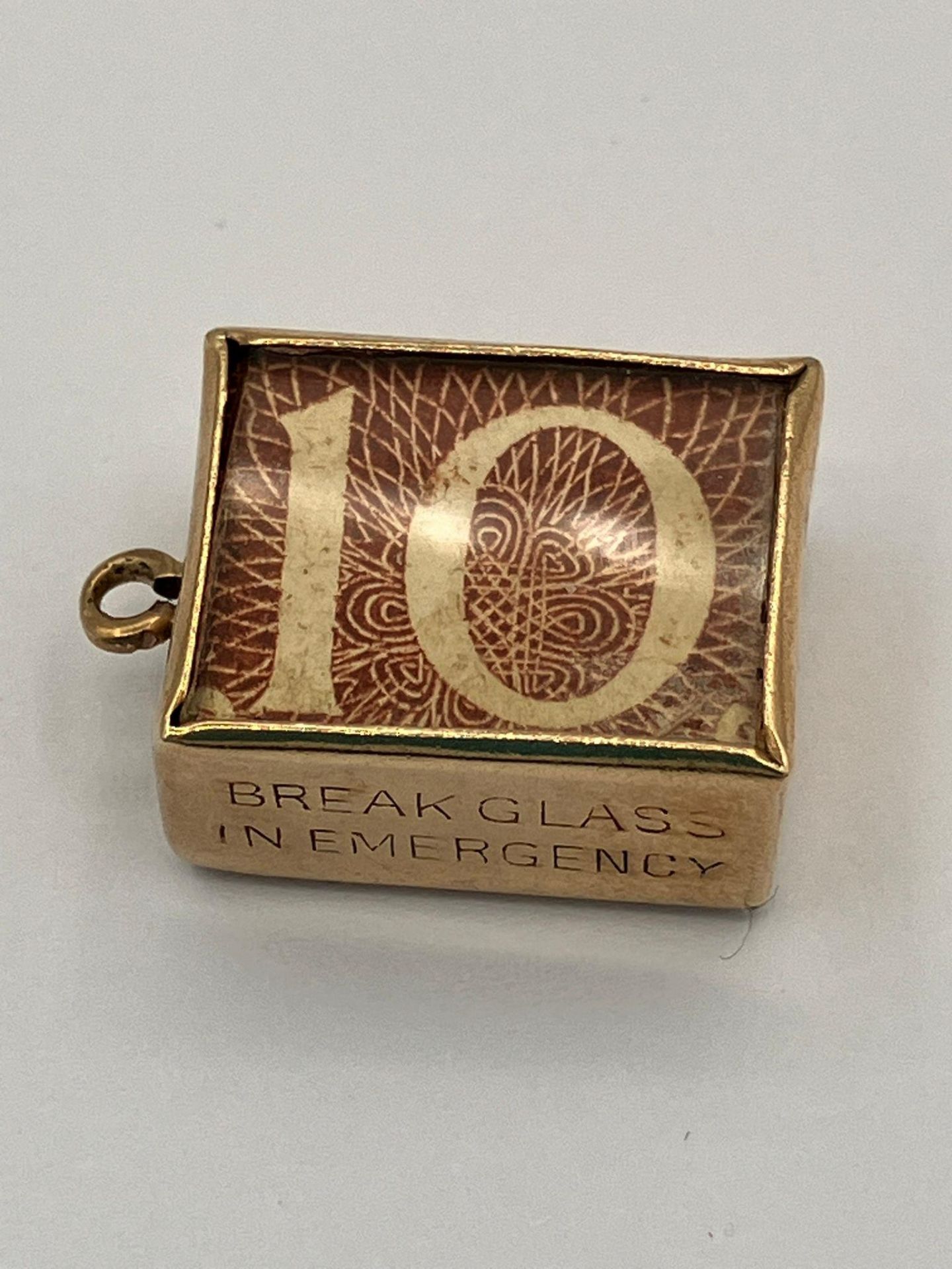 Vintage 9 carat GOLD CHARM. Having a 10 Shilling Note folded inside a GOLD CASE. Full UK Hallmark.
