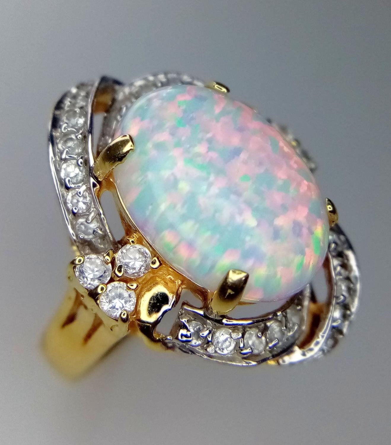 A 14K Yellow Gold and Opal Ring. White stone decoration. Size O. 6g total weight.