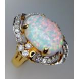 A 14K Yellow Gold and Opal Ring. White stone decoration. Size O. 6g total weight.