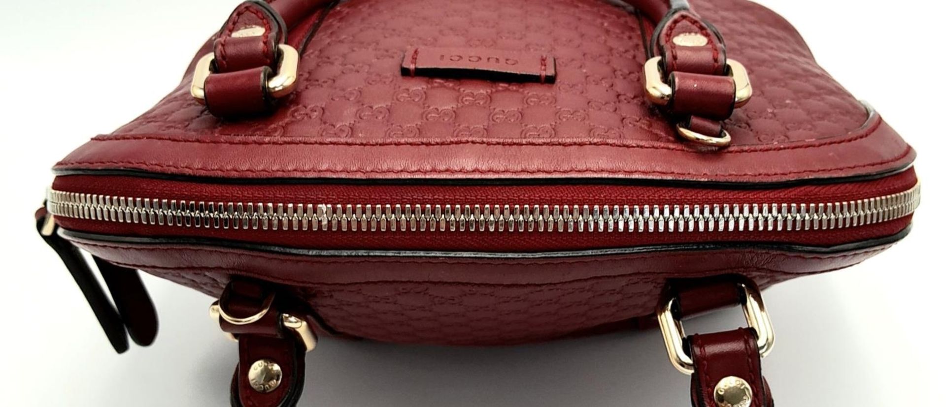 A Gucci Red Guccissima Dome Bag. Monogramed leather exterior with gold-toned hardware, two rolled - Image 5 of 10