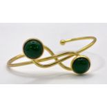 A Gilded Metal Jade Cabochon Crossover Cuff Bangle.