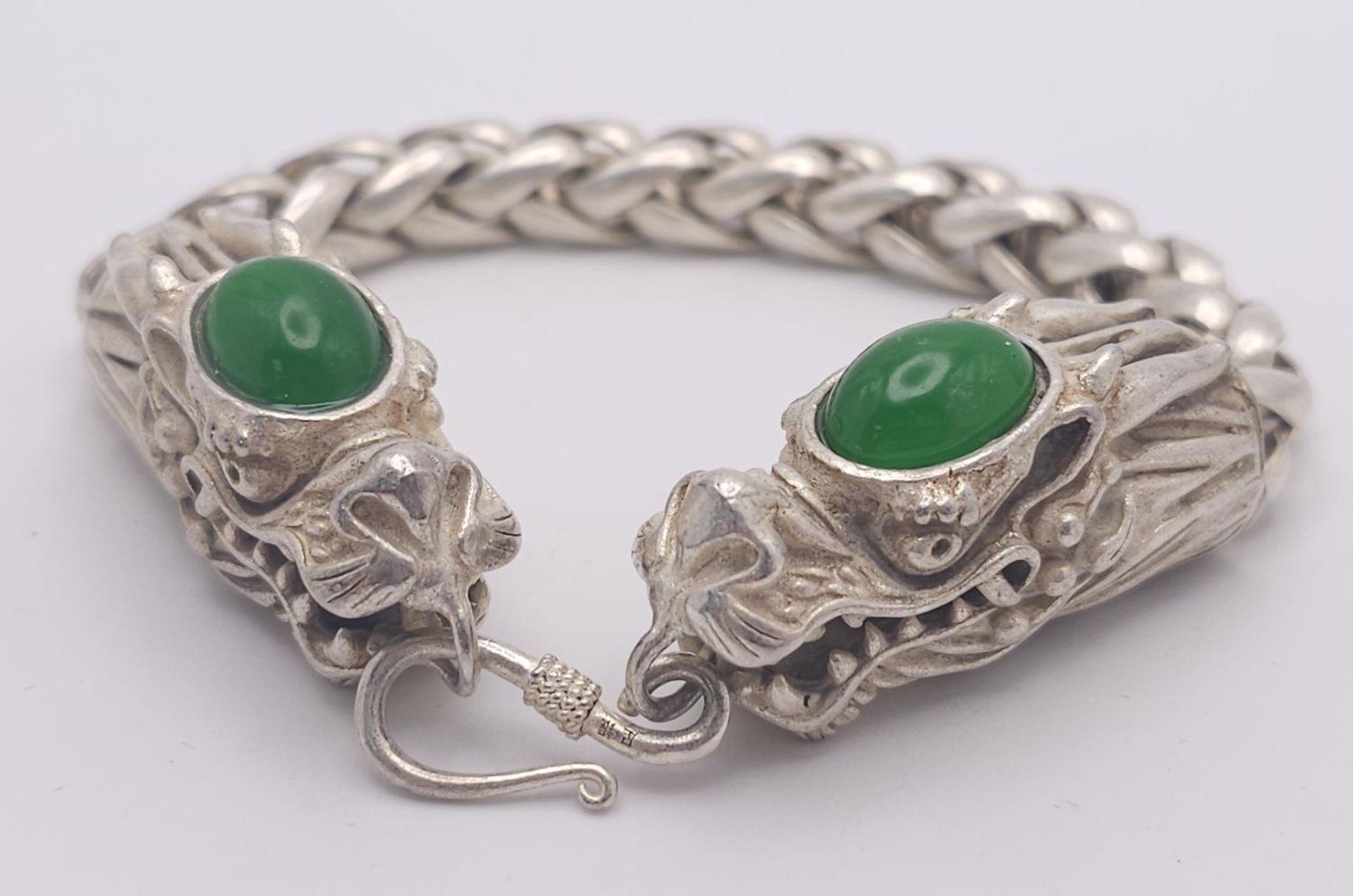 A Tibetan Silver Twin Dragon Head Bracelet. Jade cabochon decoration. 20cm.