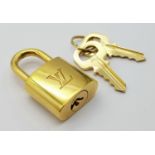 A Louis Vuitton Gold Plated Lock with Two Keys.