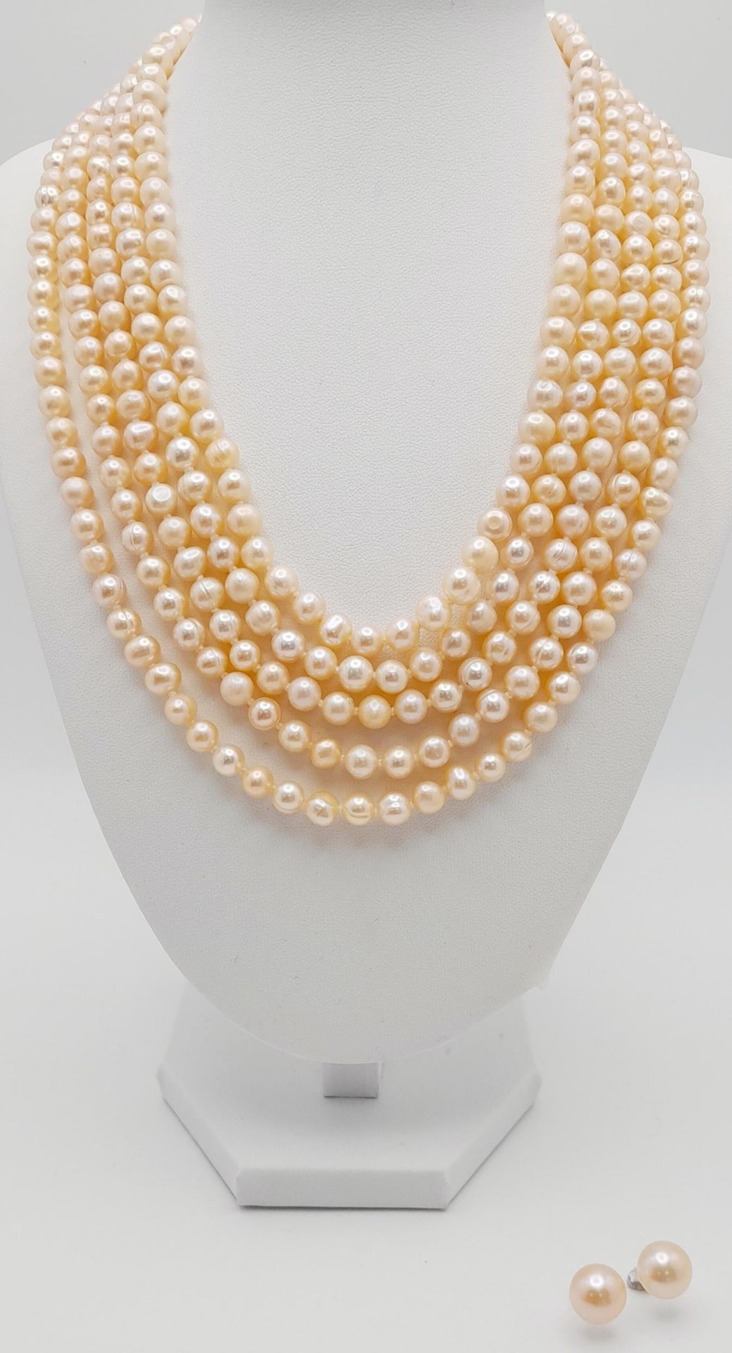 A statement five row pink, cultured pearl necklace accompanied by a pair of pink pearl stud