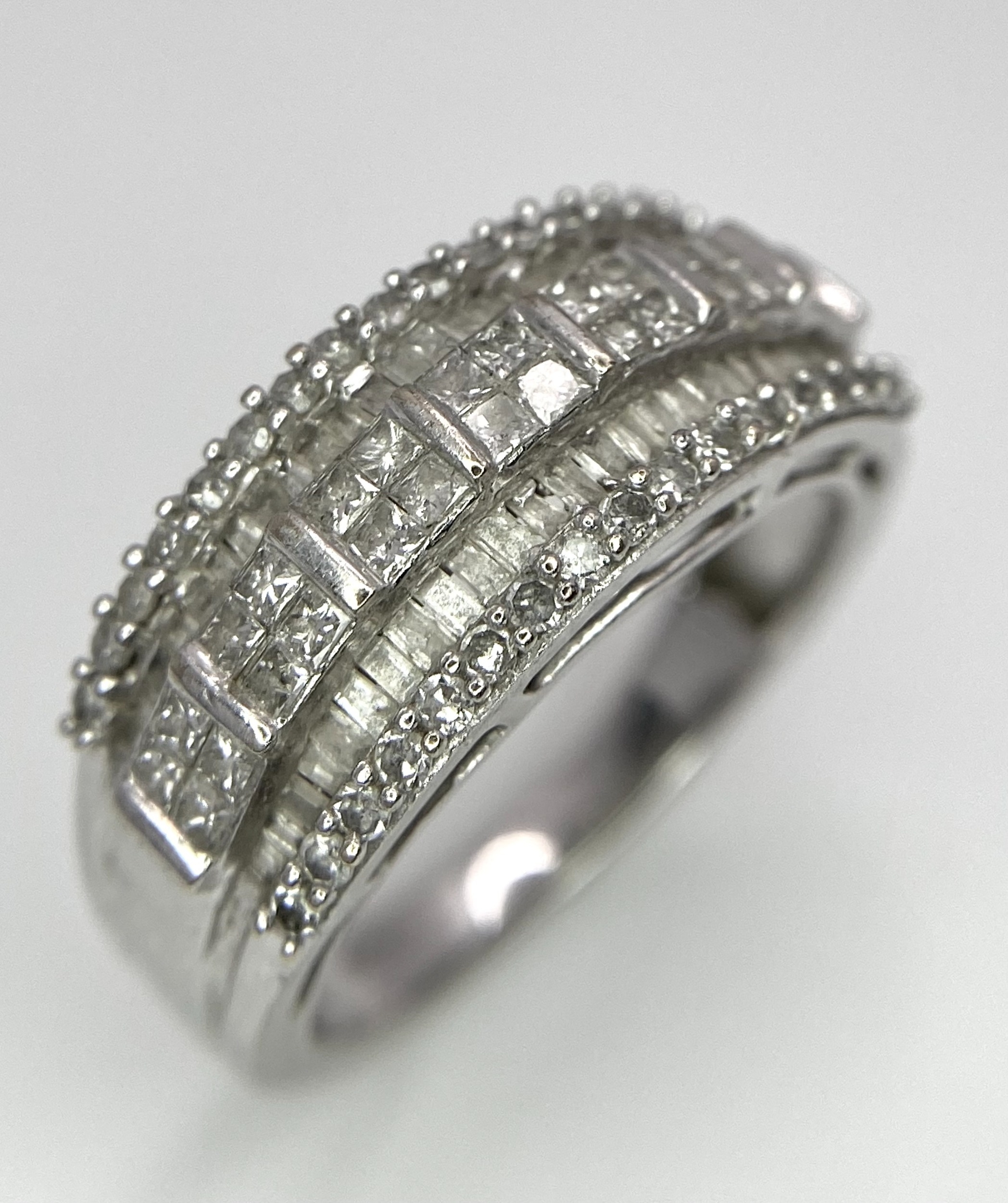 A 9K White Gold Mixed Cut Diamond Ring. Five rows of, square, round and baguette cut diamonds. - Image 2 of 7