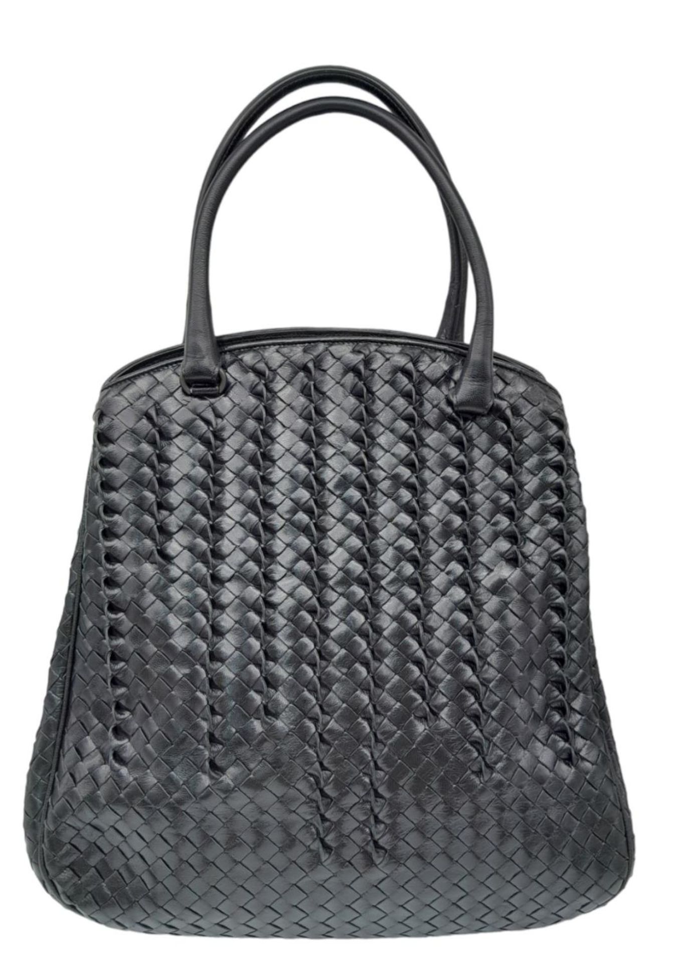 A Bottega Veneta Black Bag. Intrecciato leather exterior with two rolled leather handles. Beige