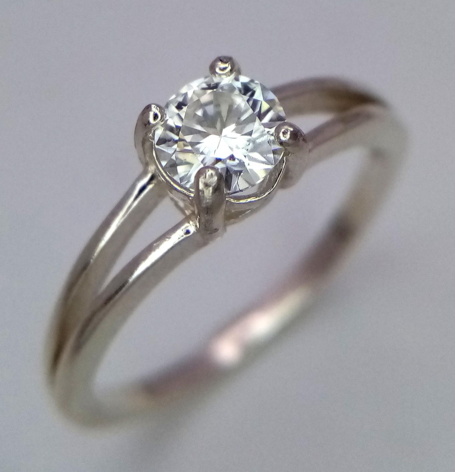 A 0.5ct Moissanite Solitaire Ring. Set in 925 silver. Comes with a GRA certificate. Size M.