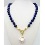 A Lapis Lazuli Beaded Necklace with Baroque Pearl Pendant. 10mm beads. Pendant - 6cm. Necklace
