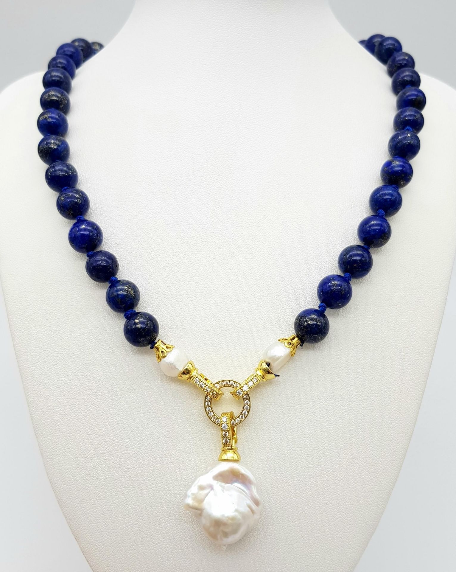 A Lapis Lazuli Beaded Necklace with Baroque Pearl Pendant. 10mm beads. Pendant - 6cm. Necklace