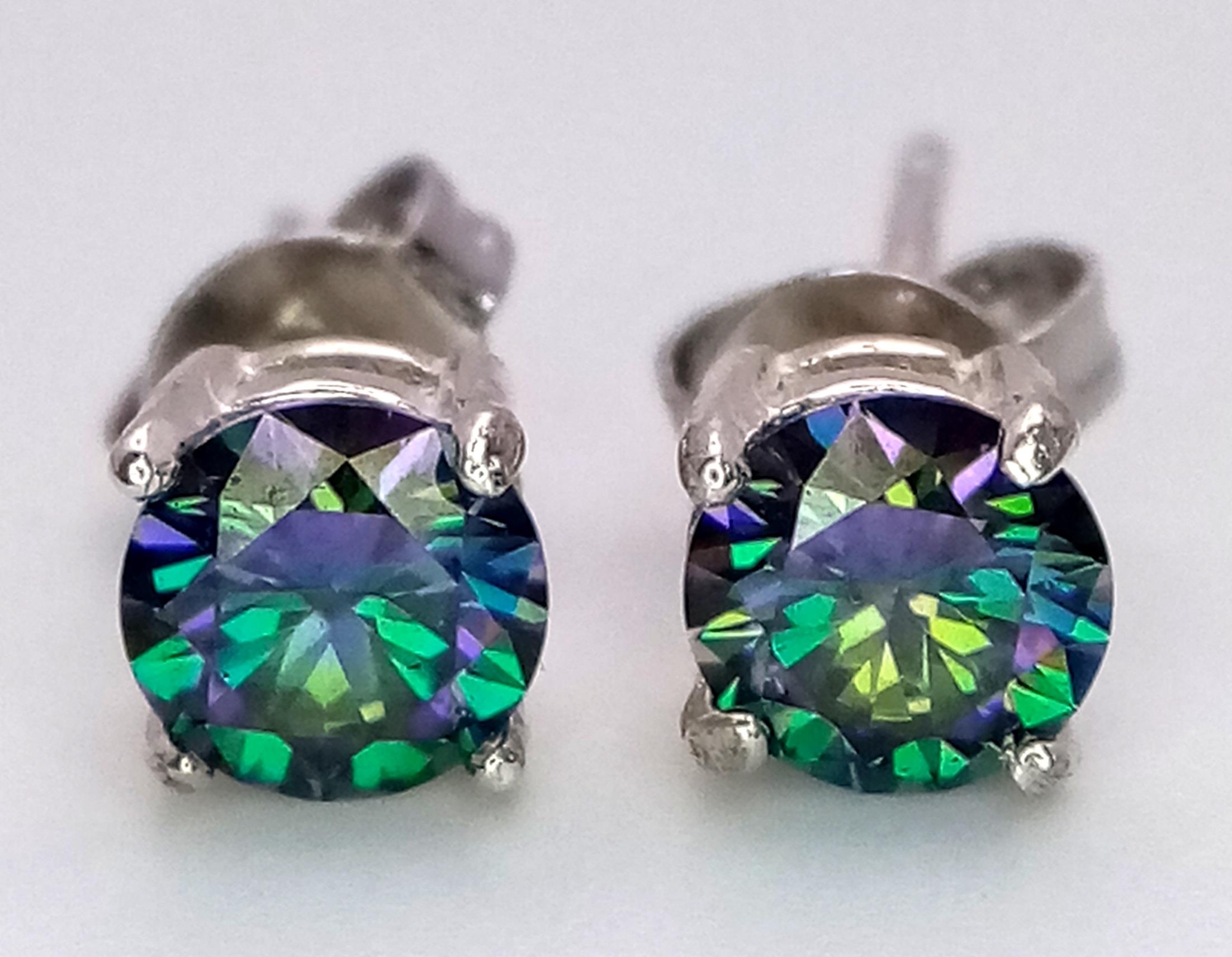 A Pair of 0.5ct Rainbow Moissanite Stud Earrings. Set in 925 silver. Both come with GRA