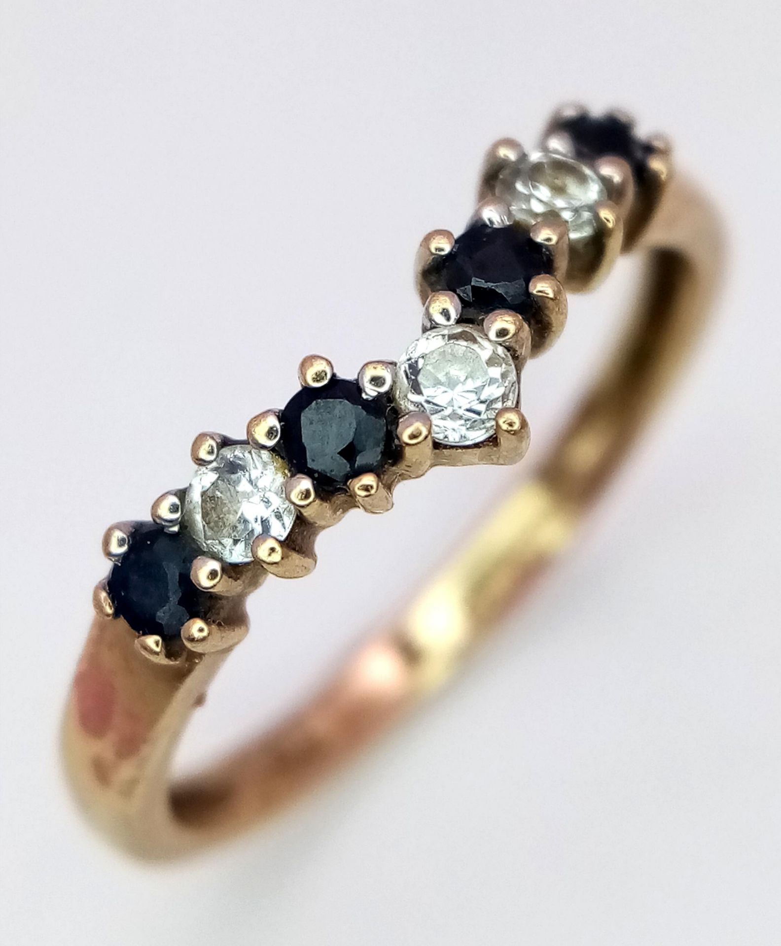 A 9K Yellow Gold Sapphire and White Zircon Chevron Ring. Size M. 1.5g total weight.