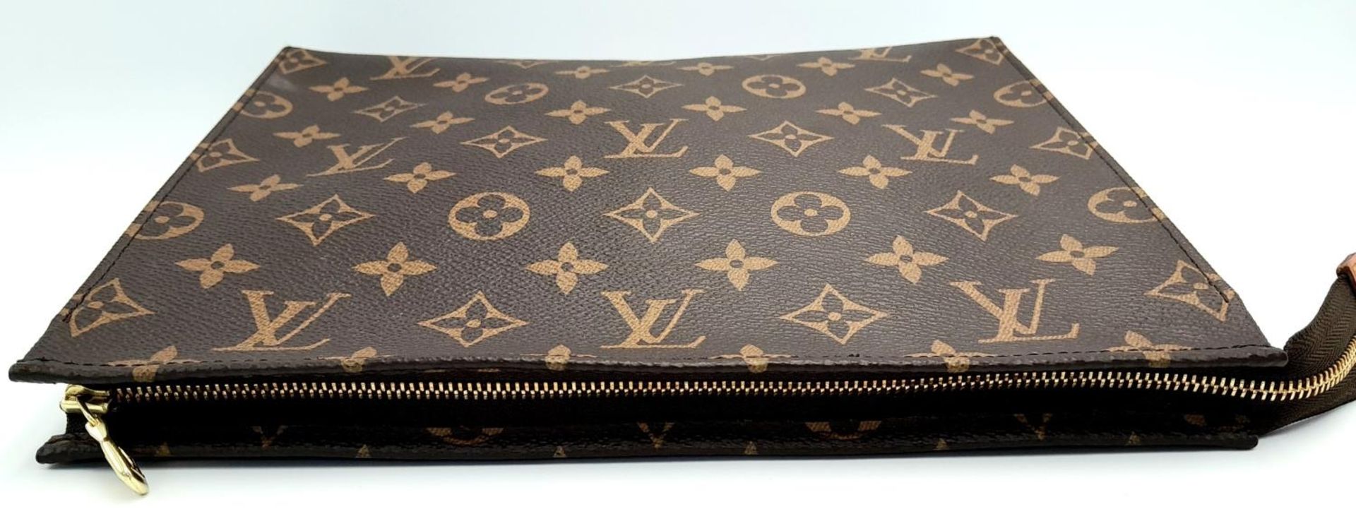 A Louis Vuitton Toiletries Pouch. Monogramed canvas exterior with gold-toned hardware and zipped top - Image 6 of 9