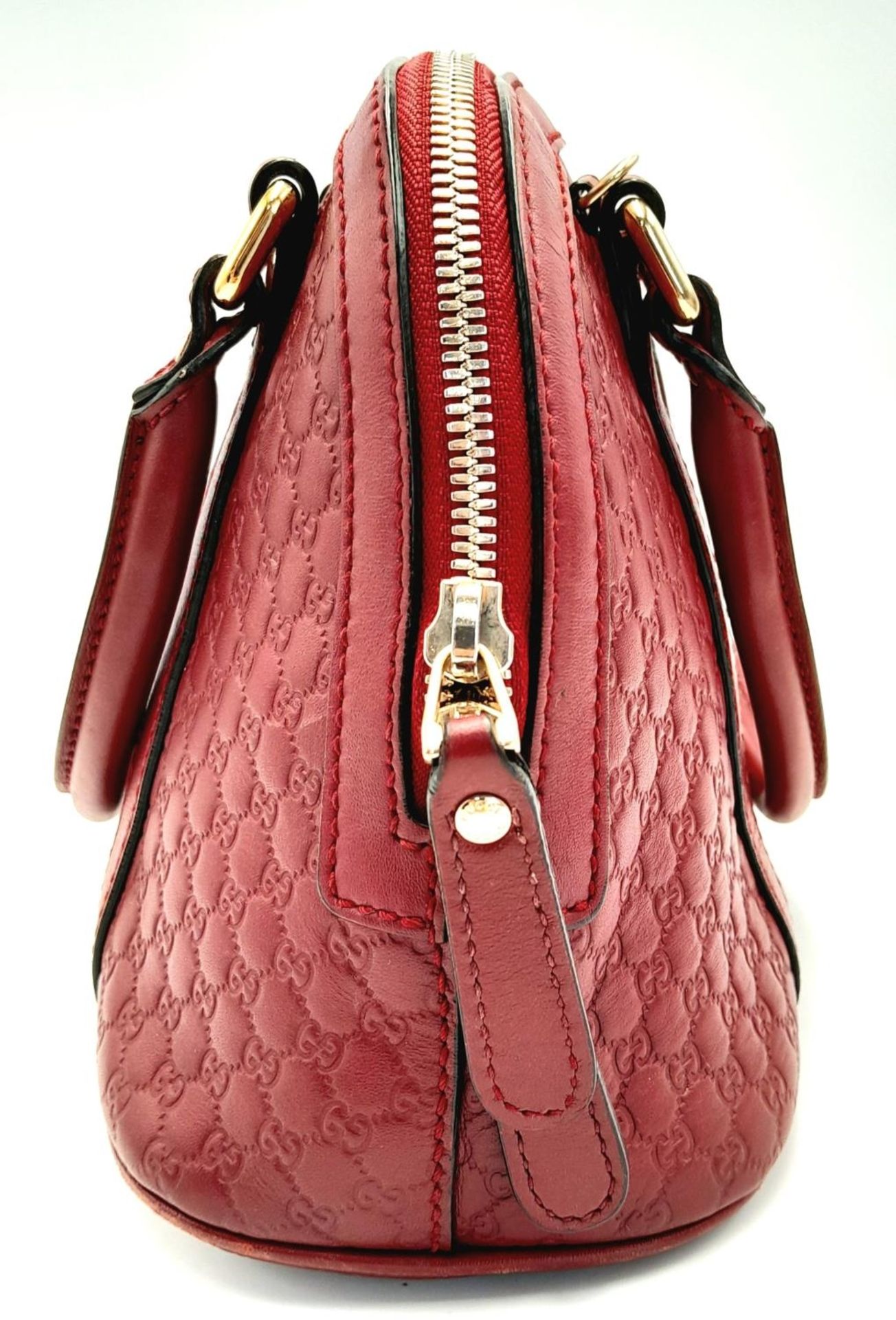 A Gucci Red Guccissima Dome Bag. Monogramed leather exterior with gold-toned hardware, two rolled - Image 4 of 10