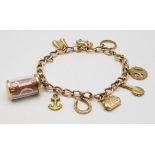 A 9K Gold Charm Bracelet. 10 charms including: 10 shilling note, handbag and binoculars! 18cm