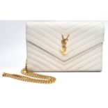 A YSL Ivory Cassandre Wallet Bag. Leather exterior with gold-toned hardware, the iconic YSL logo,