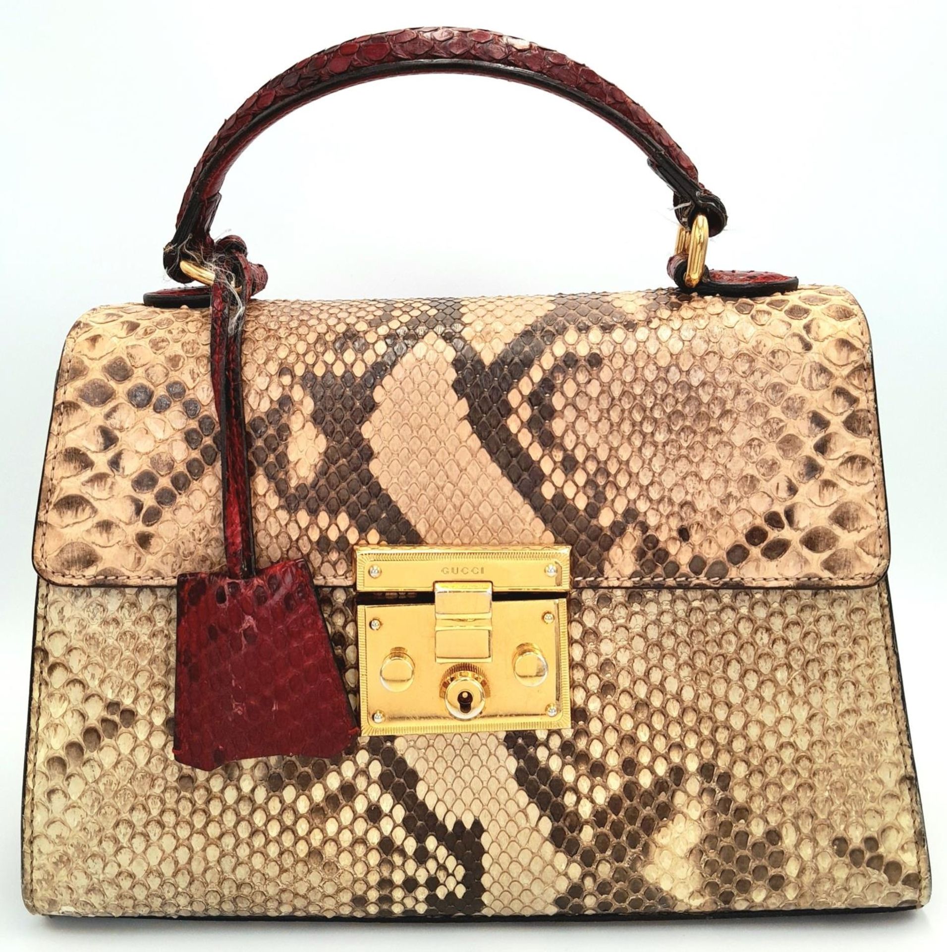 A Gucci Multi-Colour Python Padlock Bag. Python skin and leather exterior with gold-toned