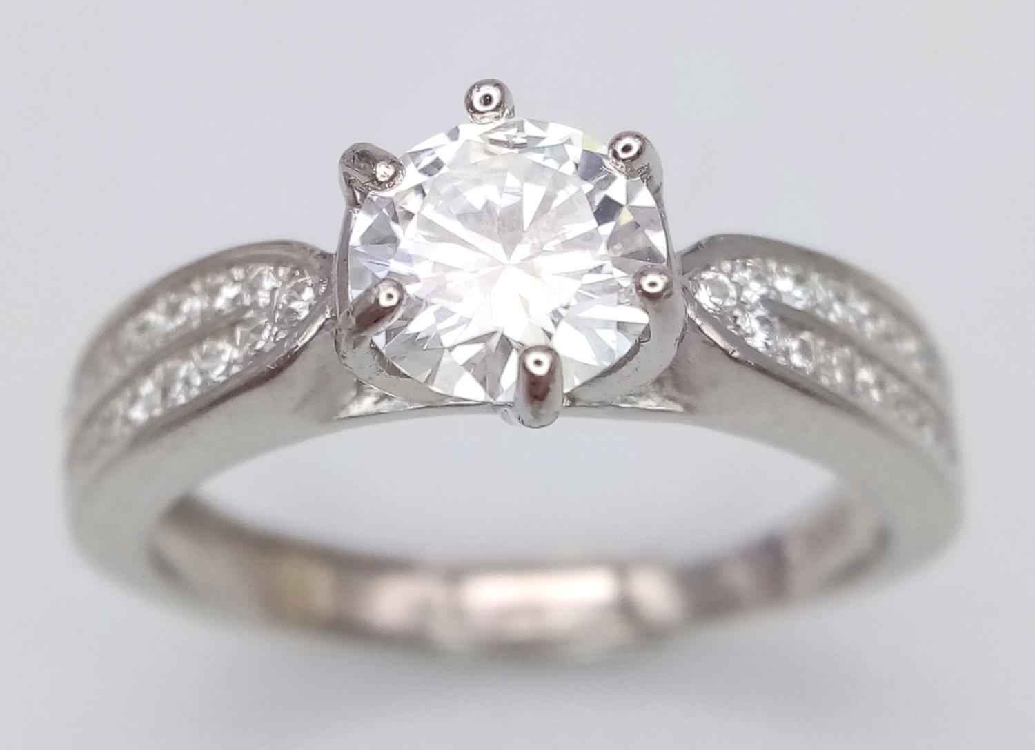 A 1ct Moissanite 925 Silver Ring. Size O. Comes with a GRA certificate.