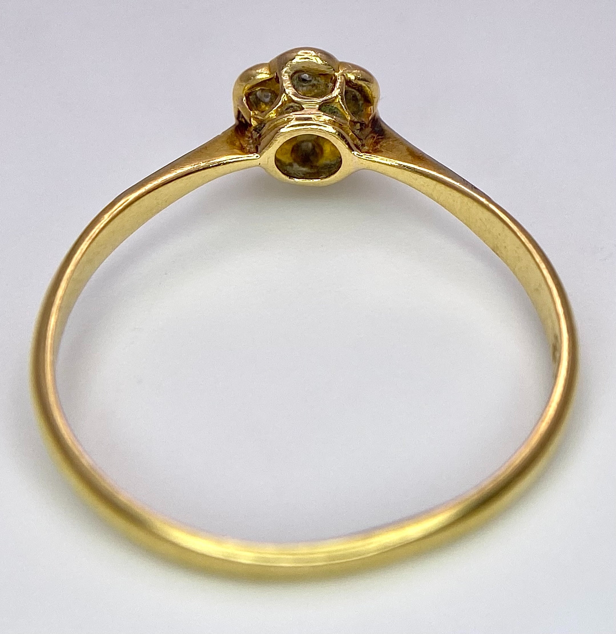 An 18K Yellow Gold, Platinum Diamond Ring. Size Q. Seven old cut diamonds in a decorative floral - Image 5 of 6