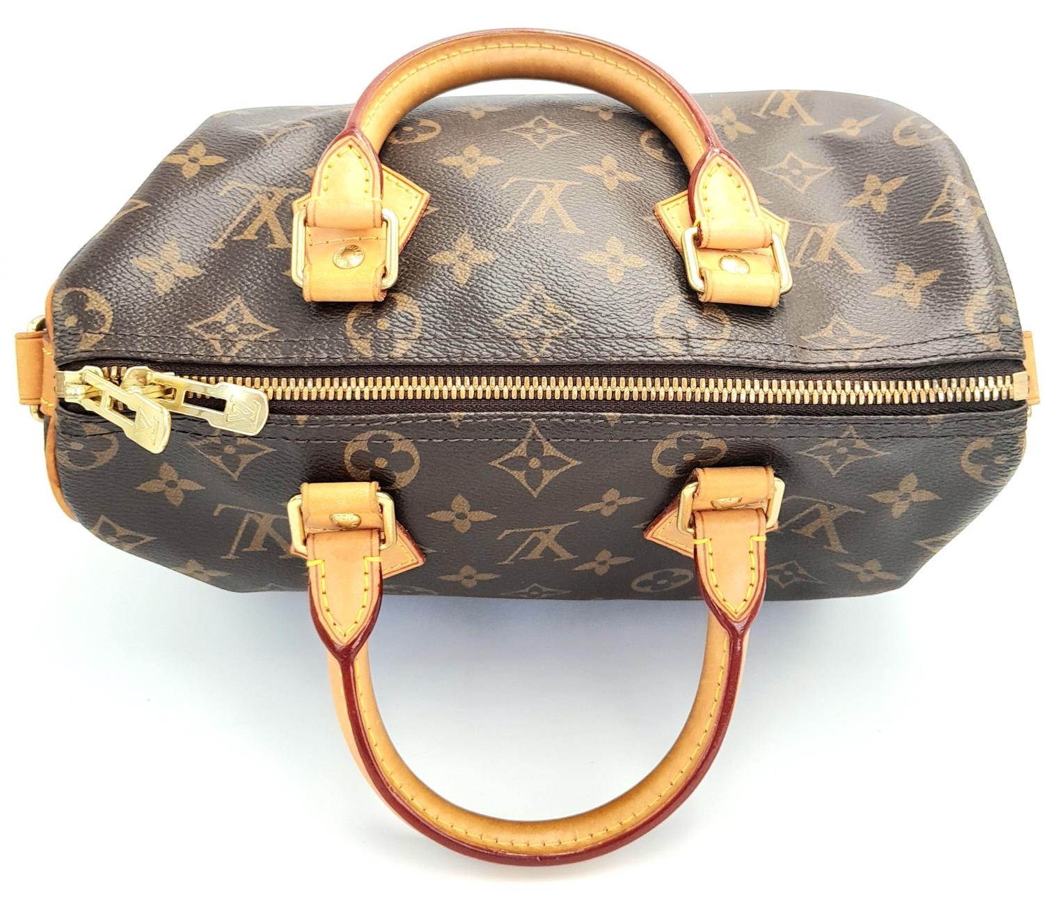 A Louis Vuitton Speedy Bag. Monogramed canvas exterior with gold-toned hardware, two rolled - Image 5 of 12
